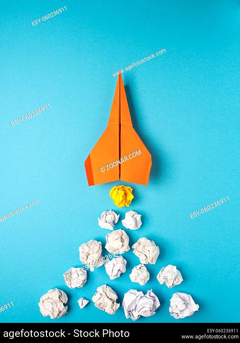 Launching paper rocket with jet stream of paper balls, creativity concept or new ideas metaphor, start up business , new year?s resolution