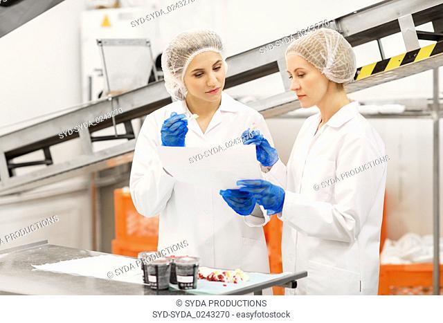 women technologists tasting ice cream at factory