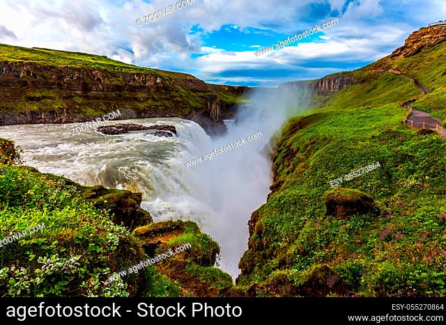 Iceland. Gullfoss - Golden Waterfal on the Hvitau River. Water foam and fog fly up over falls. The concept of extreme and phototour