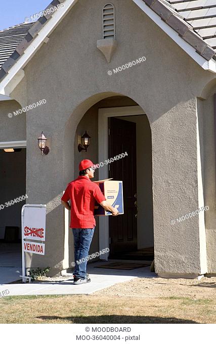 Delivery man holding Cardboard box