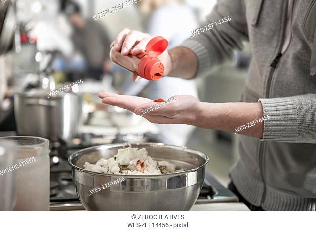 Close-up of man preparing meal in kitchen