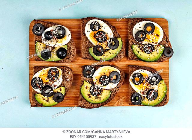 Bruschetta with avocado and olives. Useful food, healthy snack. top view
