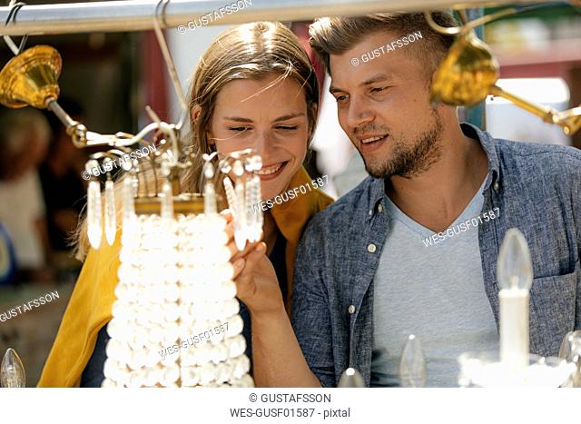 Belgium, Tongeren, happy young couple on an antique flea market
