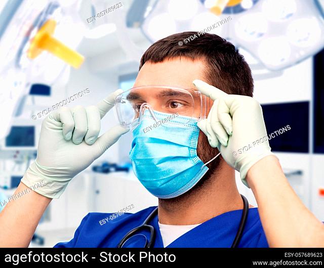 male doctor in goggles, mask and gloves