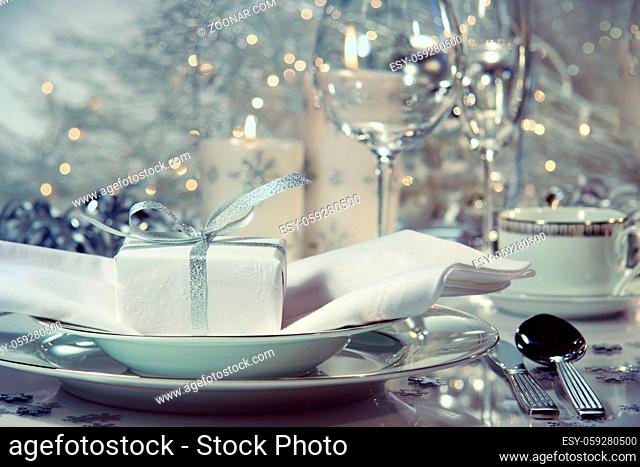 Closeup of dinner setting with gift for the holidays
