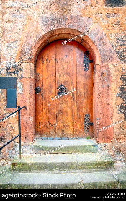 An image of an old vintage red wooden door Marburg Germany