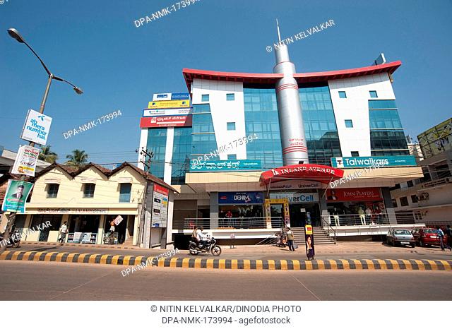 Old structure and modern building ; Mahatma Gandhi road ; Mangalore ; Karnataka ; India 2010