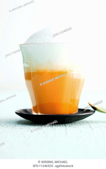 A carrot and orange cappuccino