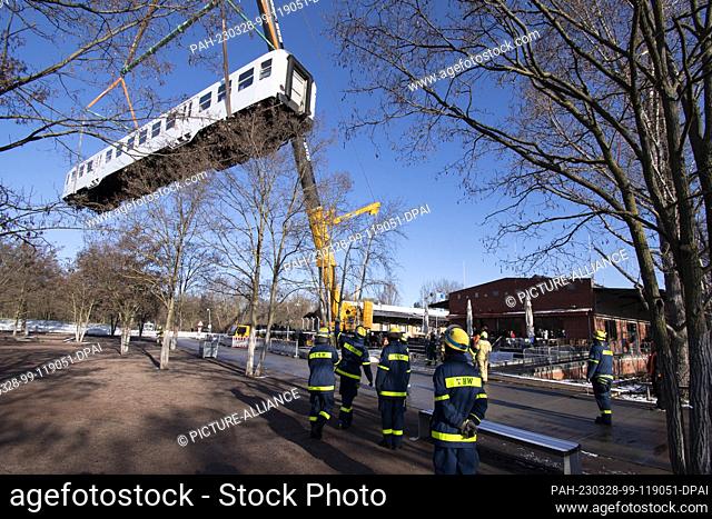 28 March 2023, Berlin: The KIMBAexpress of the Berliner Tafel is placed on a track at the Museum of Technology with the help of an oversized crane truck and the...