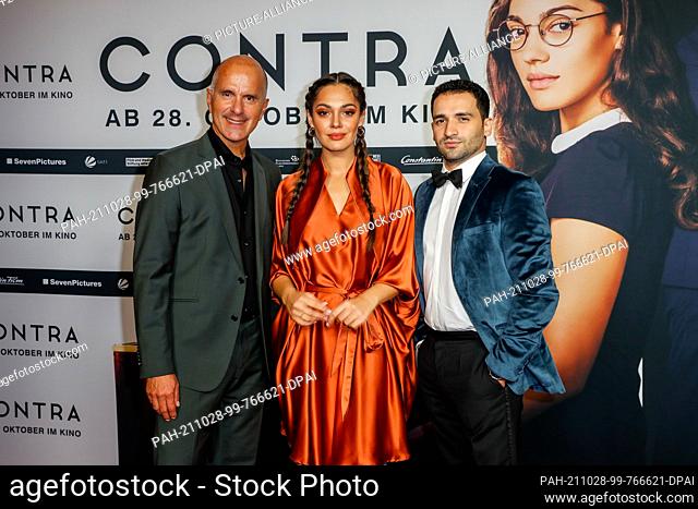 27 October 2021, Berlin: Christoph Maria Herbst (l-r), Nilam Farooq and Hassan Akkouch arrive at the premiere of the film ""Contra"" at the Zoo Palast cinema