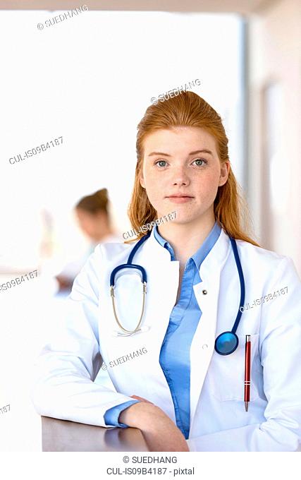 Portrait of red haired young female doctor in hospital