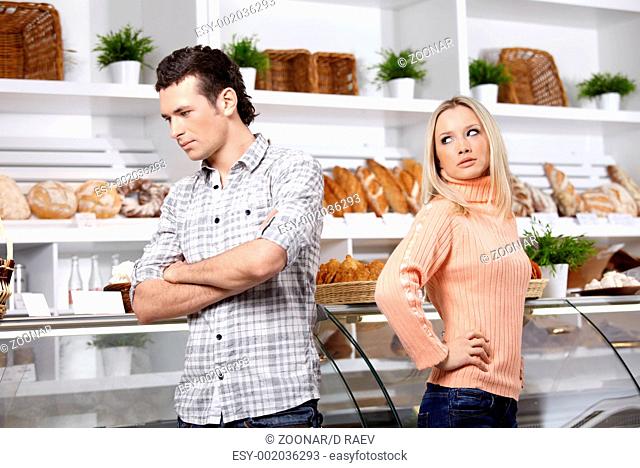 The young man and the girl have quarrelled in shop