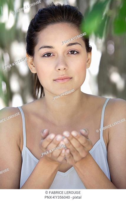 Portrait of a beautiful young woman holding bath salt in hand