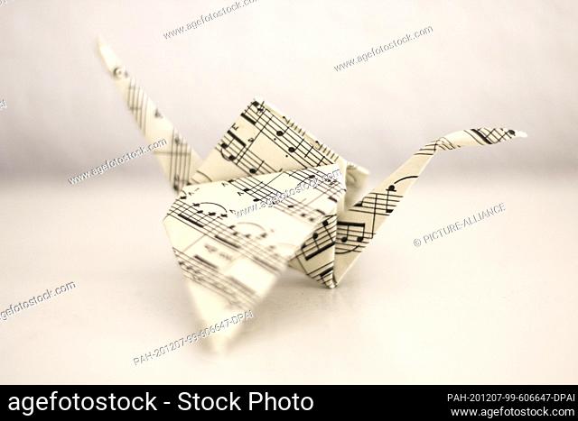 25 February 2018, Saxony-Anhalt, Magdeburg: A crane made of music paper, Japanese paper folding art Origami. Photo: Stephan Schulz/dpa-Zentralbild/ZB