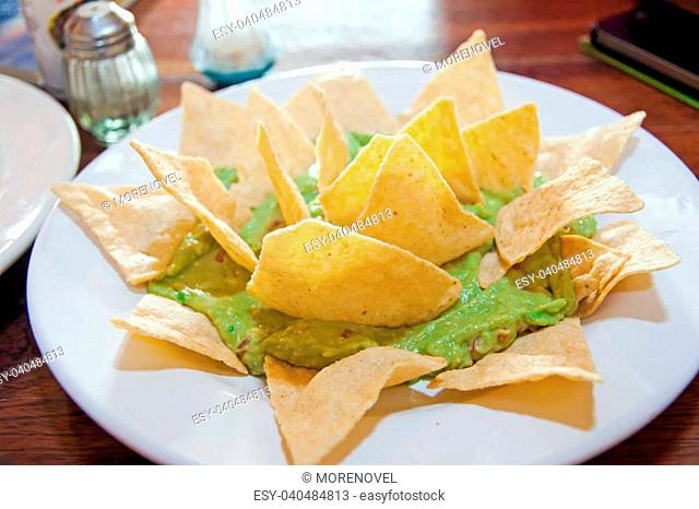 A dish of mexican guacamole with tacos