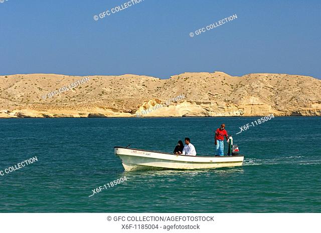 Young local couple on a boat trip in the pittoresque Barr Al Jissah bay at the Gulf of Oman near Muscat, Sultanate of Oman