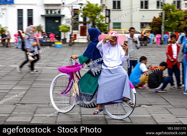 Indonesian People Cycling In Taman Fatahillah Square, Jakarta, Indonesia