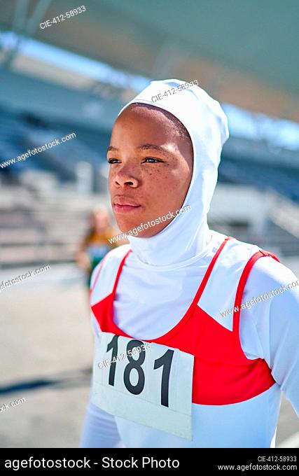 Portrait confident female track and field athlete in hijab