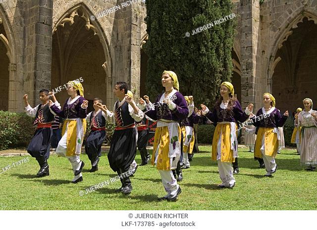 Local men and women in traditional costume dancing, folk dance, folklore, Bellapais Abbey, Beylerbeyi, Abbey de la Pais, monastery ruin, near Kyrenia