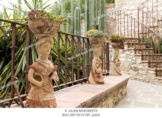 Statued potted plants with stairs in the background; San Miguel de Allende; Mexico