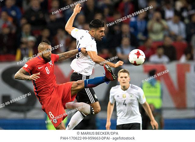 Germany's Emre Can (C) and Chile's Arturo Vidal vie for the ball during the Confederations Cup group stages Group B soccer match between Germany and Chile in...