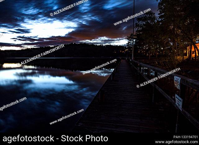 Stockholm, Sweden A midsummer midnight sun view over a dock on lake Malaren. | usage worldwide. - STOCKHOLM/Sweden