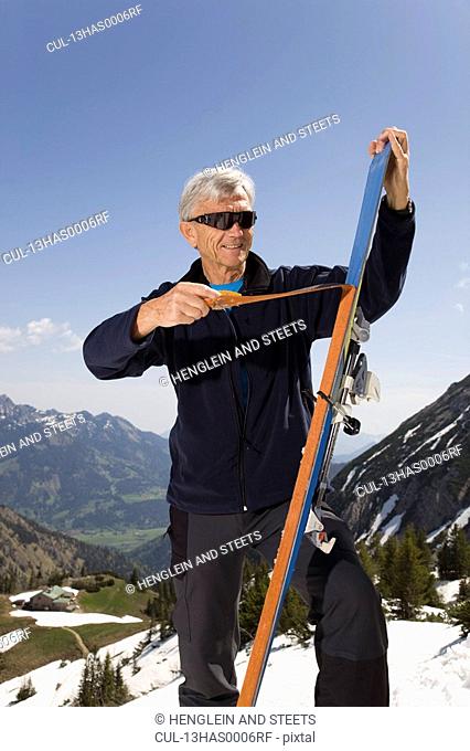 senior man on ski tour in mountains
