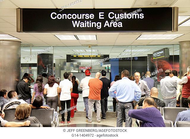 Florida, Miami, Miami International Airport, MIA, terminal, concourse, Hispanic, man, woman, families, arrival waiting area, sign, Customs
