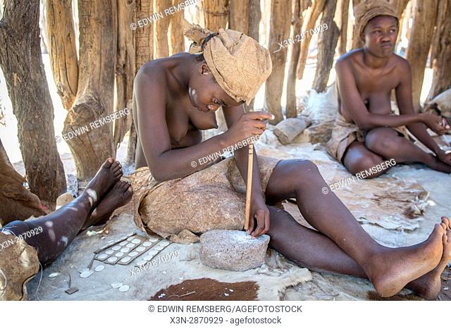 Damaran women making buttons out of bone at the Damara Living Museum, located north of Twyfelfontein in Namibia, Africa