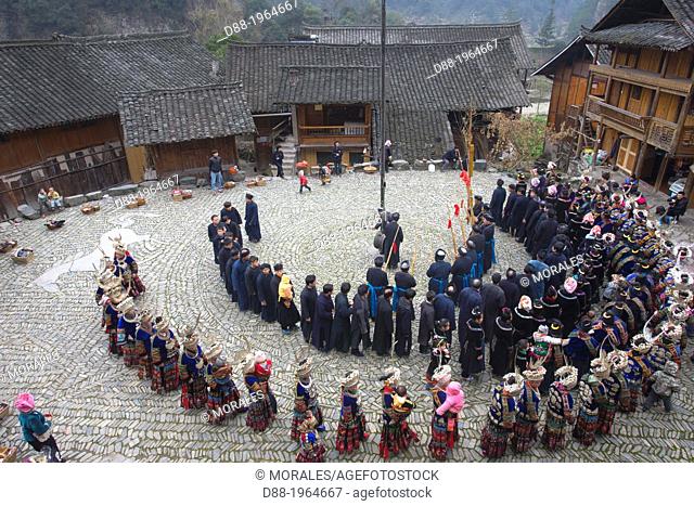 China , Guizhou province , Langde village , Long Skirt Miao people in traditional dress , mens are playing lusheng ,
