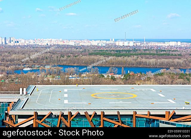 Helipad on the roof of the building on the city background. Early spring, sunny day. Kiev, Ukraine