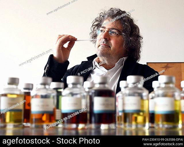PRODUCTION - 03 April 2023, Baden-Württemberg, Karlsruhe: Perfumer Roland Tentunian takes a scent sample of a developed perfume recipe in his company...