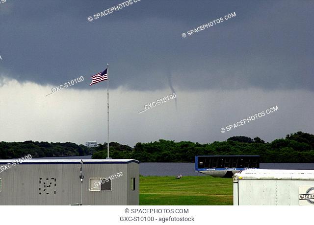 08/27/2002 -- A small water spout forms east of Launch Complex 39, Kennedy Space Center. The American flag is flying at the Press Site