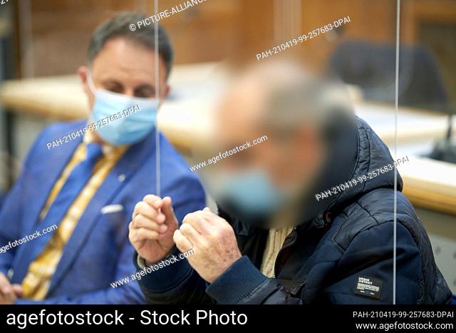 PRODUCTION - 14 April 2021, Rhineland-Palatinate, Kobenz: The defendant Anwar R. (r) sits in the dock of the Higher Regional Court next to his lawyer