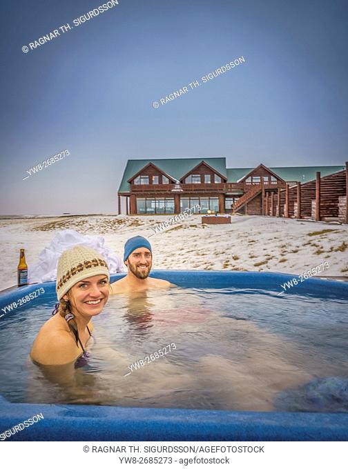People enjoying the hot tub at Hotel Ranga in the winter, Iceland. Hot tubs are popular in Iceland all year round