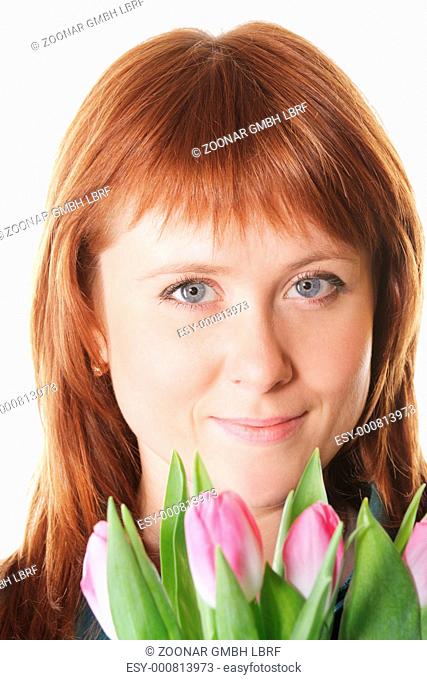 Serene redhead with pink tulips