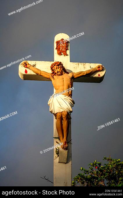 Statue of Jesus Christ on the cross near Haapiti church in Moorea island. French Polynesia