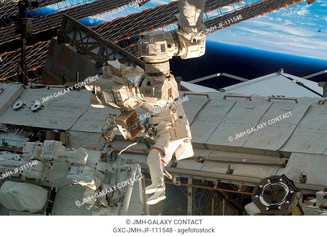 Astronaut Rick Linnehan, STS-123 mission specialist, participates in the mission's first scheduled session of extravehicular activity (EVA) as construction and...