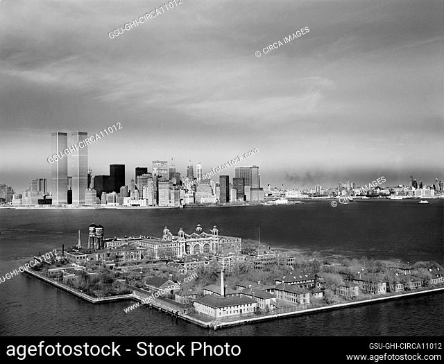 Ellis Island with Manhattan Skyline in background, World Trade Center Towers to left, New York City, New York, USA, Historic American Buildings Survey...