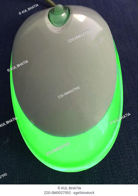 A glowing green optical mouse. The color changes every few seconds