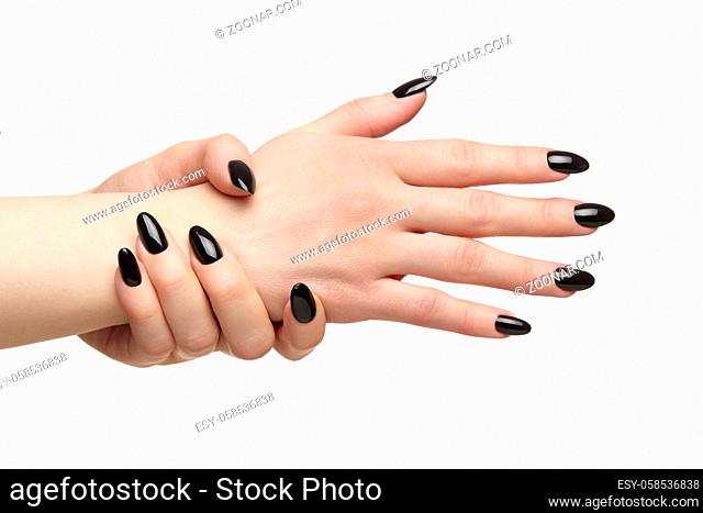 Female hands with black nails manicure. Isolated on white background