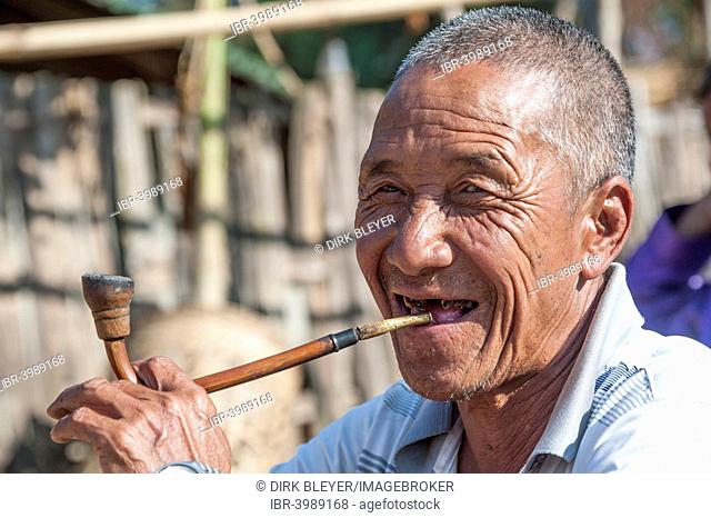 Elderly man from the Akha people, hill tribe, ethnic minority, smoking a pipe, portrait, Chiang Rai Province, Northern Thailand, Thailand