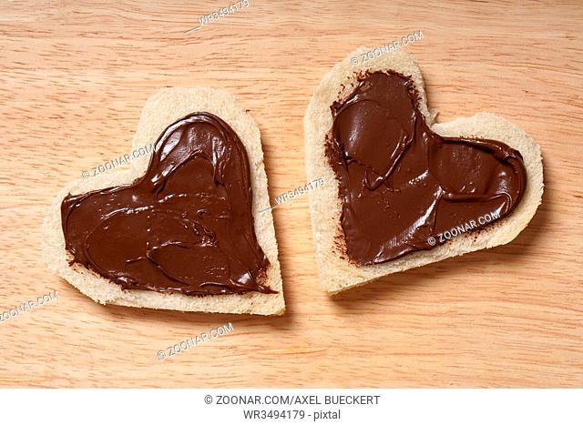 two heart shaped bread slices with chocolate spread for Valentine's day