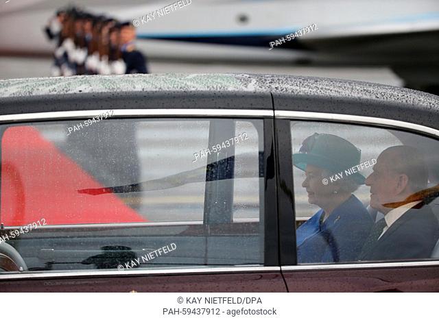 British Queen Elizabeth II and her husband Prince Philip, Duke of Edinburgh, sit in a Bentley car after arriving at Tegel airport in Berlin, Germany