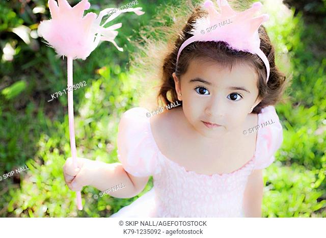 Little girl playing dress up as a princess