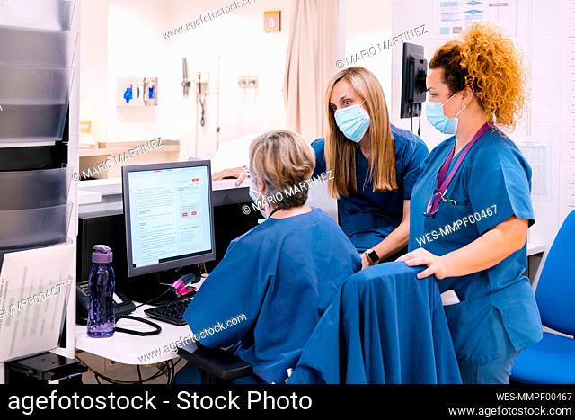 Nurses wearing protective face mask having discussion at hospital