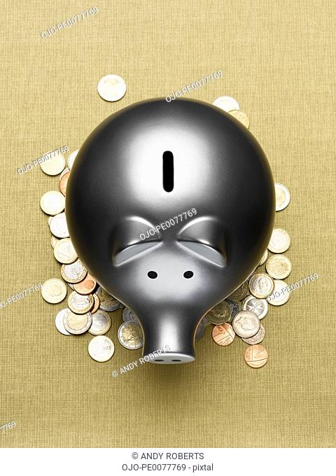 Piggy bank sitting on pile of coins