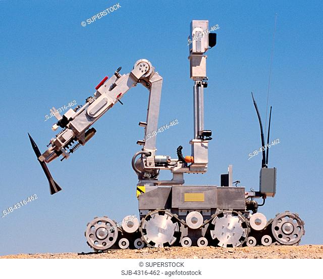 An Explosive Ordnance Disposal Robot Grips a Depleted Uranium Sabot Round