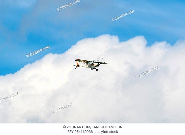 Small engine airplane flying among the clouds