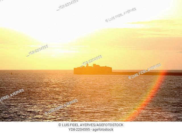 Sunset at the output of the industrial port of Cherbourg in France